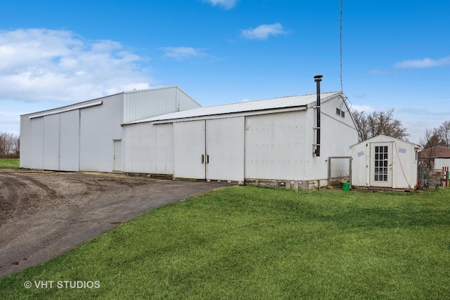 view of outbuilding with a yard