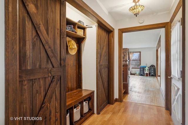 mudroom with light hardwood / wood-style flooring