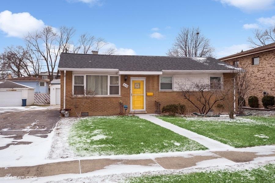 view of front of property with a garage, an outdoor structure, and a front yard