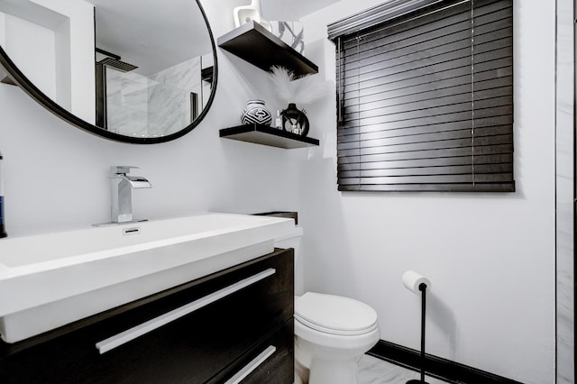 bathroom with vanity, toilet, and walk in shower