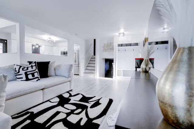 living room featuring light wood-type flooring and ceiling fan