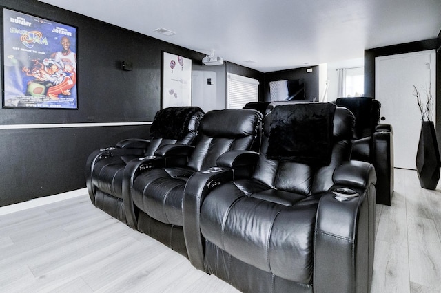 cinema featuring light hardwood / wood-style flooring