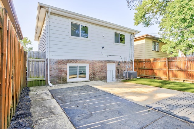 back of house featuring cooling unit and a patio area