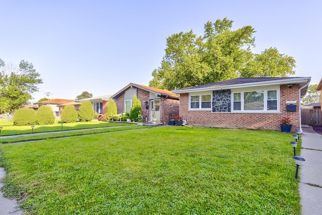 single story home featuring a front yard