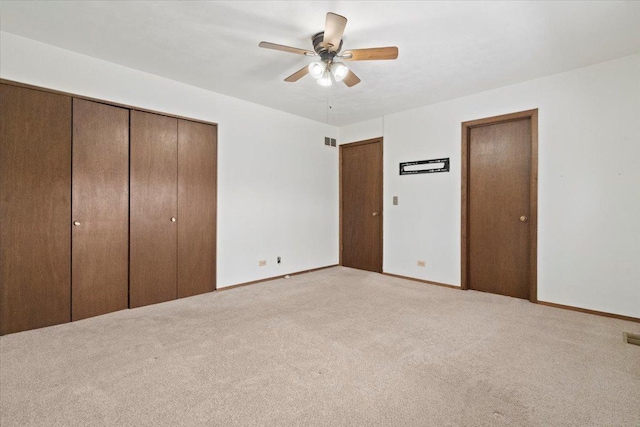 unfurnished bedroom with light carpet and ceiling fan