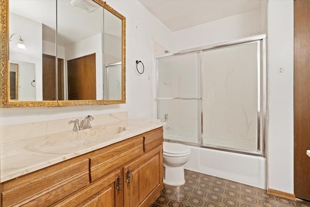 full bathroom featuring bath / shower combo with glass door, toilet, and vanity