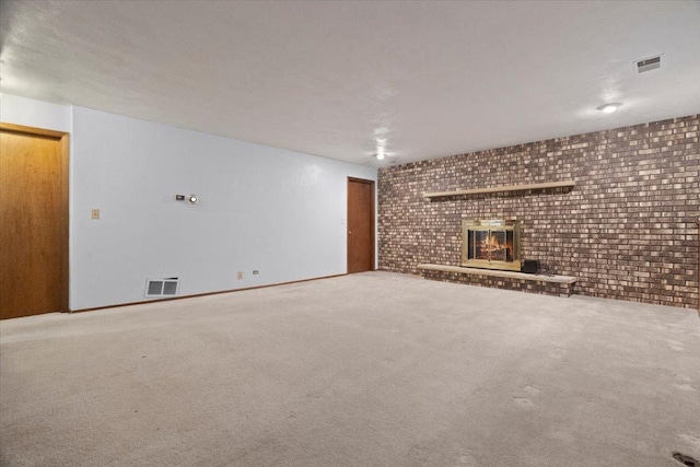 unfurnished living room featuring a brick fireplace and carpet flooring