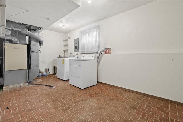 clothes washing area featuring electric panel and independent washer and dryer