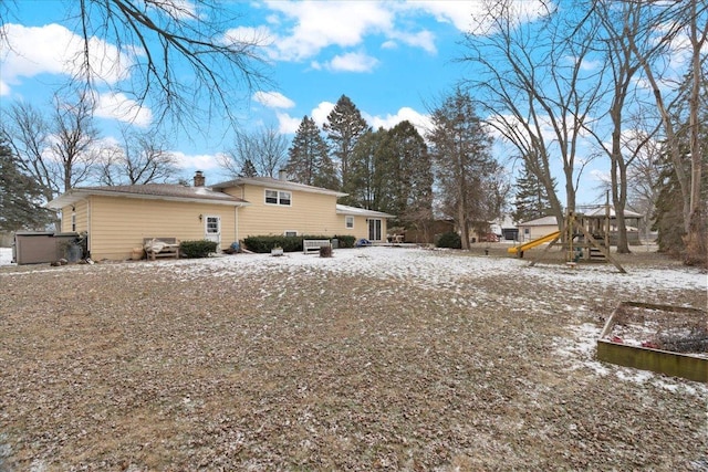 snow covered property with a playground