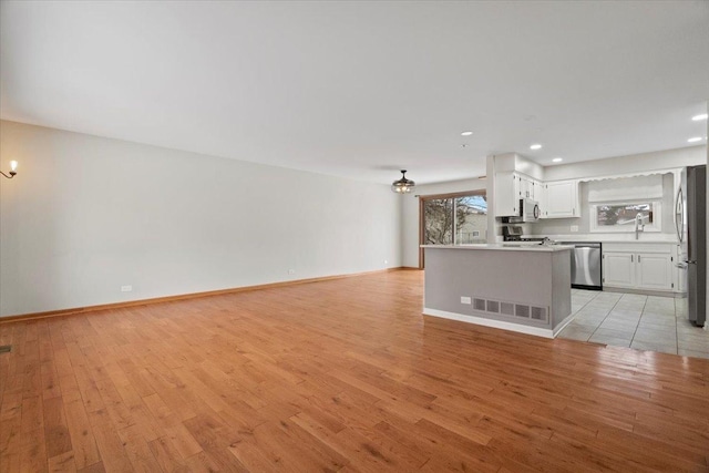 unfurnished living room featuring light wood-type flooring