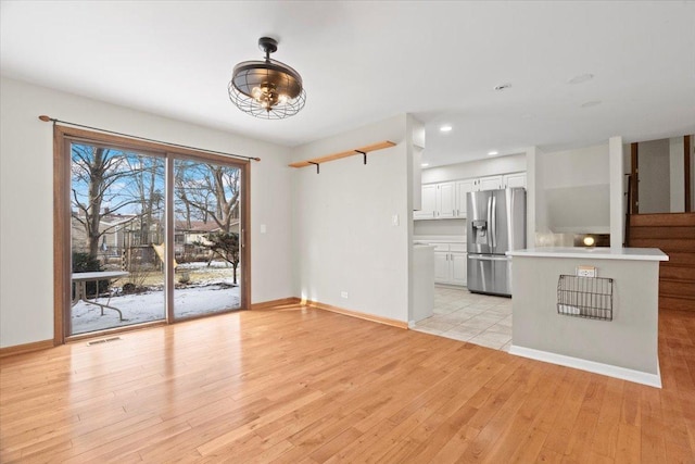 unfurnished living room with light wood-type flooring