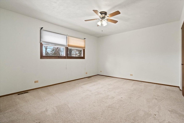 unfurnished room featuring ceiling fan and light colored carpet