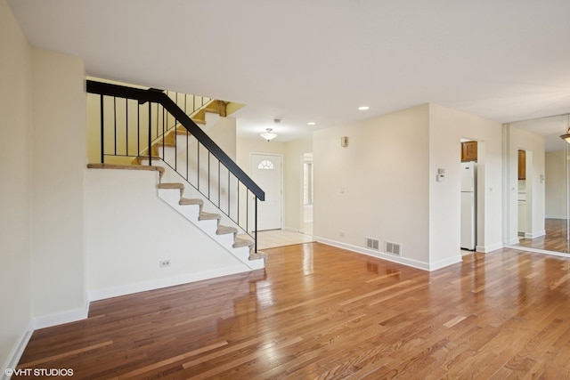 interior space with recessed lighting, stairs, baseboards, and wood finished floors