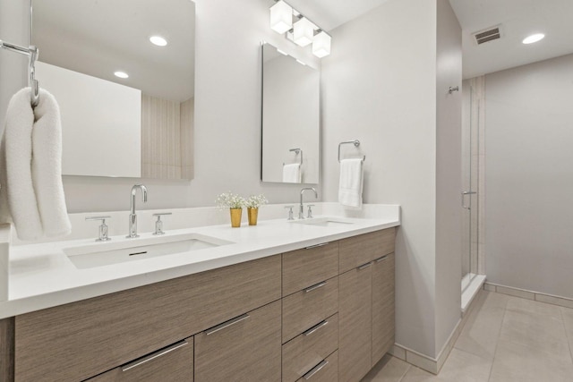 bathroom with tile patterned flooring, an enclosed shower, and vanity