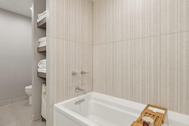 bathroom featuring tile patterned floors, toilet, and washtub / shower combination