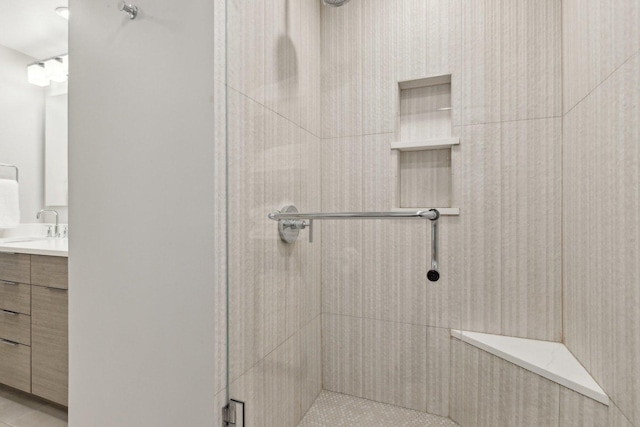 bathroom featuring vanity and a shower with door