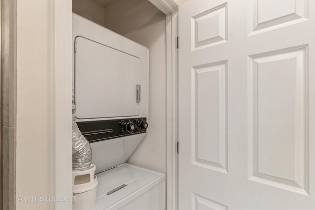 clothes washing area with stacked washer / drying machine