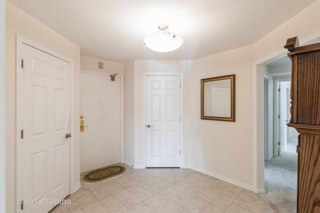 hall with light colored carpet