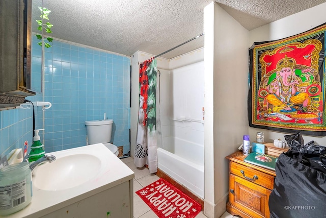 full bathroom featuring vanity, toilet, shower / bath combo, tile patterned floors, and a textured ceiling