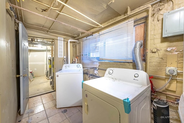 laundry area with gas water heater and washer and clothes dryer