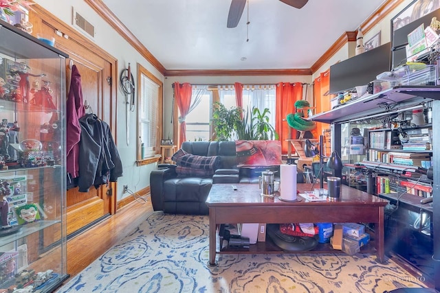 living room with ornamental molding, light hardwood / wood-style floors, and ceiling fan