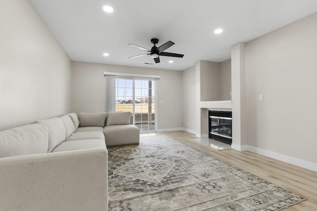 living room featuring ceiling fan and wood-type flooring