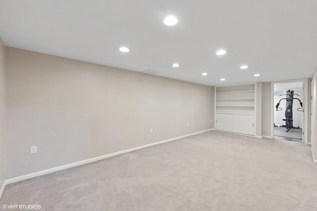 interior space with built in features and light carpet