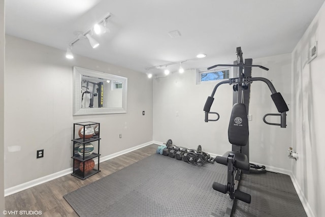 exercise area featuring dark wood-type flooring