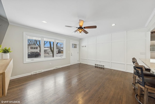 unfurnished living room featuring ornamental molding, dark wood-type flooring, and ceiling fan