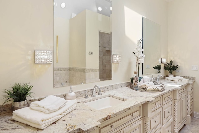 bathroom with tile patterned flooring, a sink, and double vanity