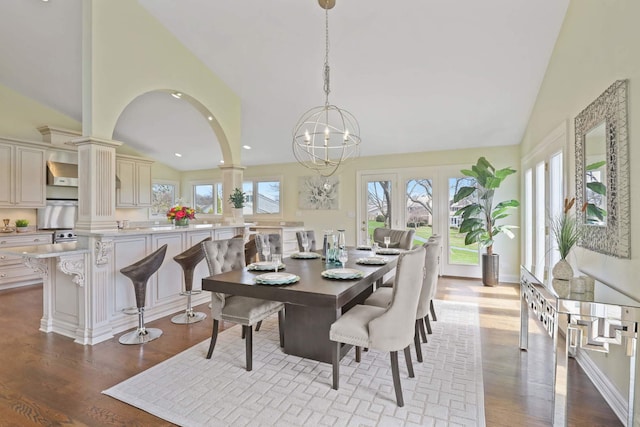 dining space featuring high vaulted ceiling, recessed lighting, wood finished floors, and a healthy amount of sunlight