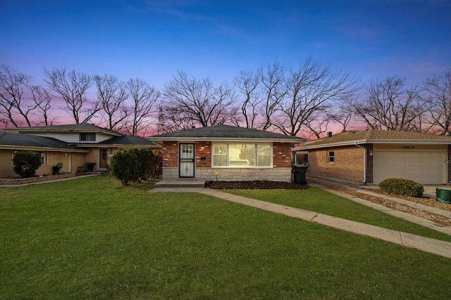 ranch-style house with a yard and a garage