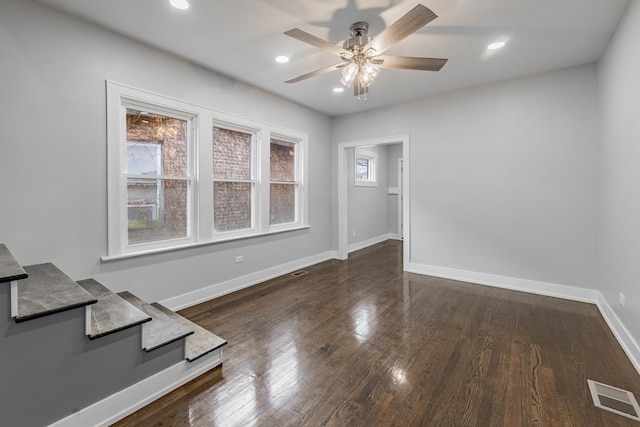 unfurnished room with ceiling fan and dark hardwood / wood-style flooring