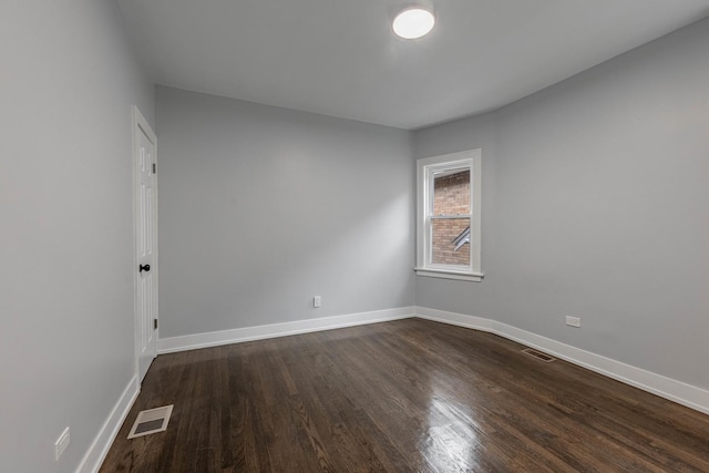 spare room with dark hardwood / wood-style flooring