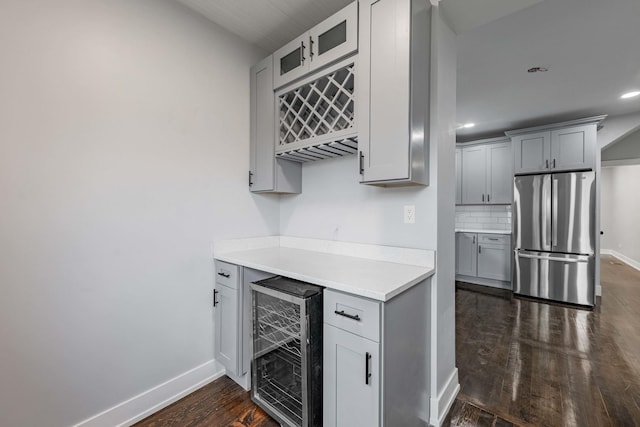 kitchen featuring stainless steel fridge, dark wood-type flooring, backsplash, beverage cooler, and gray cabinets