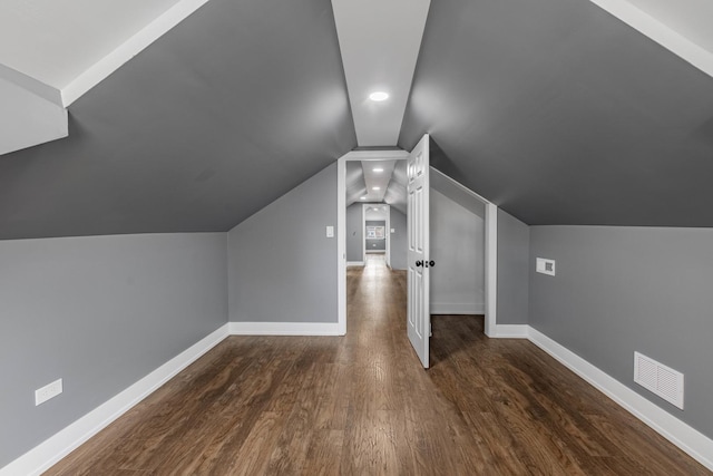 bonus room with dark wood-type flooring and lofted ceiling