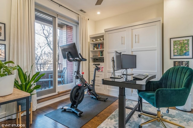 workout area with ceiling fan and dark hardwood / wood-style flooring