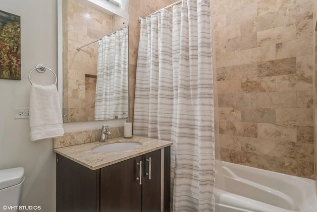 full bathroom featuring vanity, shower / bath combination with curtain, and toilet