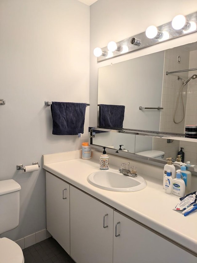 bathroom featuring toilet, vanity, and tile patterned flooring