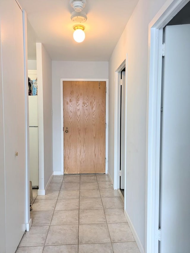 hallway featuring light tile patterned floors