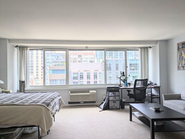 bedroom with an AC wall unit and light carpet