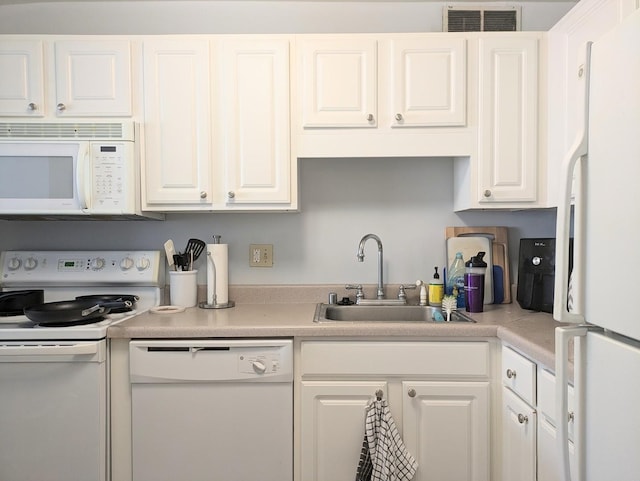 kitchen with sink, white cabinetry, and white appliances