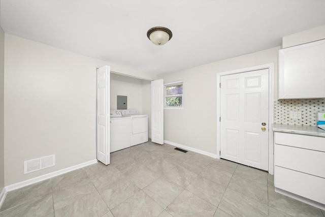 laundry area with electric panel and separate washer and dryer