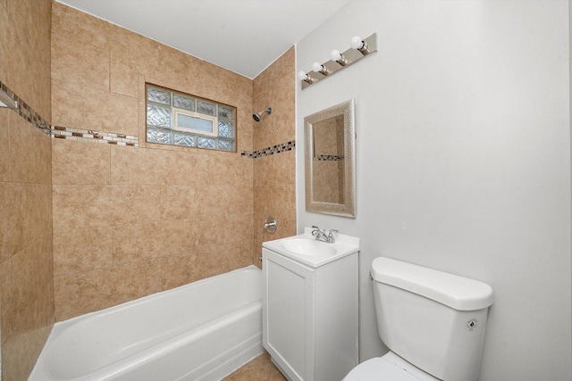 full bathroom with toilet, vanity, and tiled shower / bath