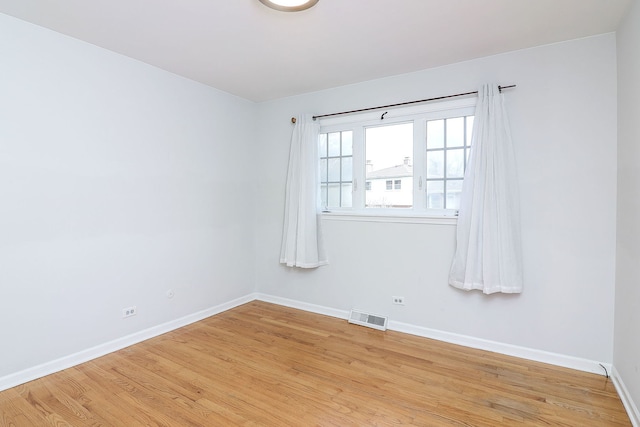 unfurnished room with light wood-type flooring