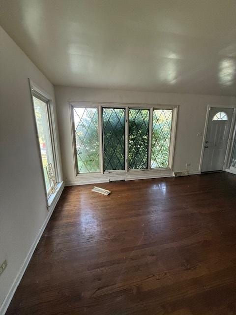 interior space with plenty of natural light and dark wood-type flooring