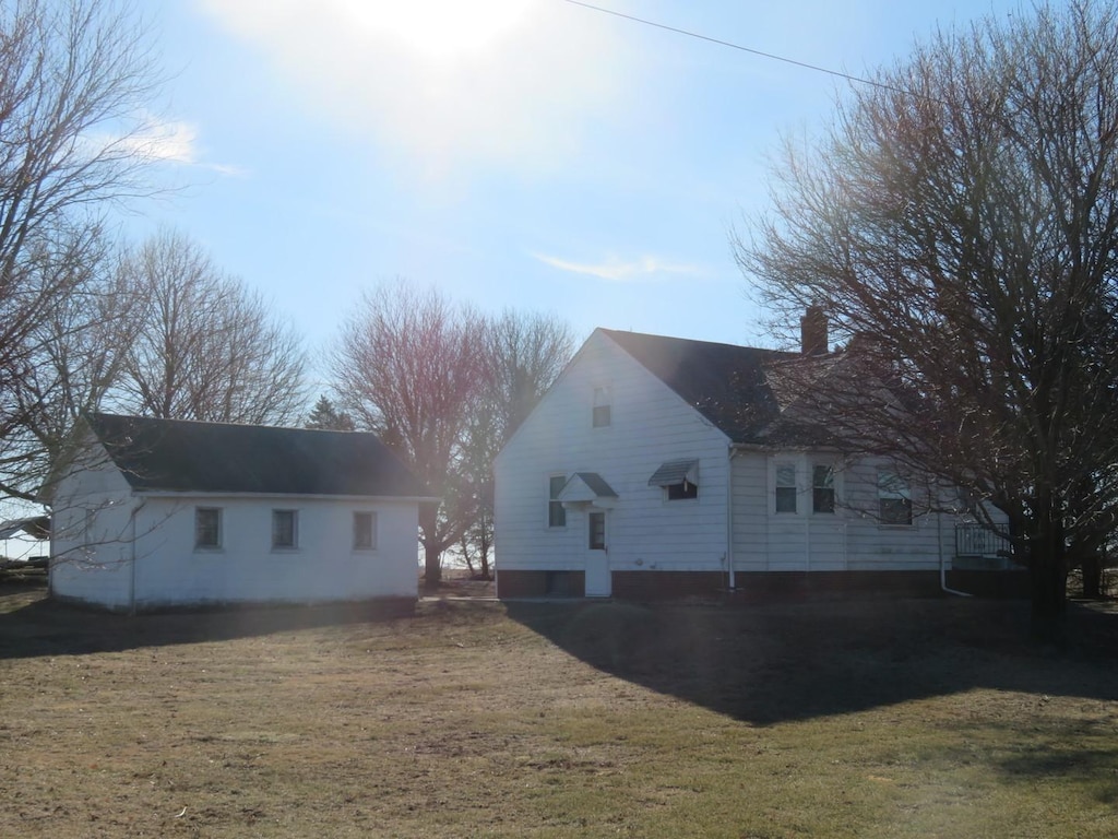 view of property exterior with a lawn