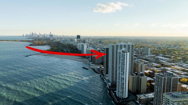 aerial view at dusk featuring a water view