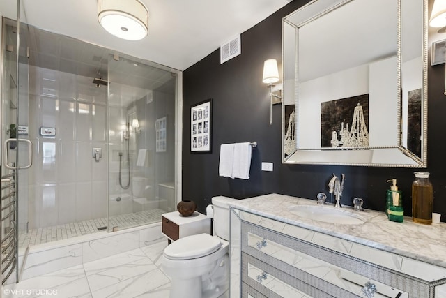 bathroom featuring vanity, an enclosed shower, and toilet