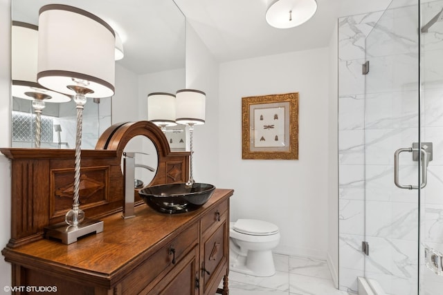 bathroom with an enclosed shower, vanity, and toilet